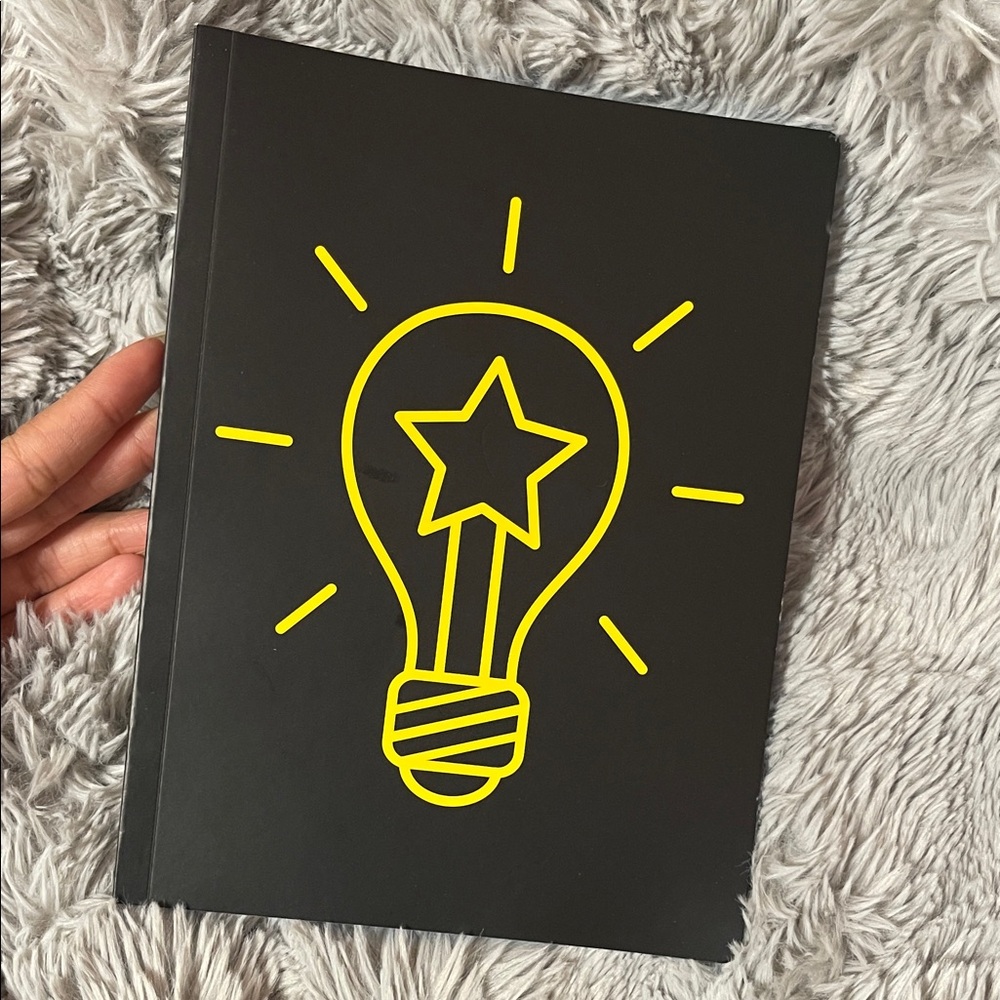 Black Notebook with Yellow Lightbulb Design